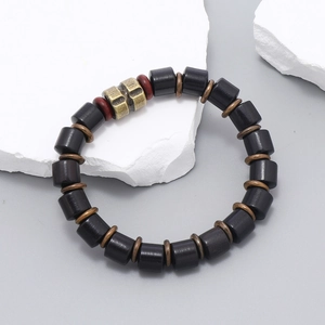 Detailed close-up of retro black wooden beads bracelet with bronze alloy accents