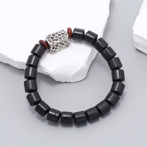 Handmade wood bead bracelet with hammered silver metal plate and elastic cord design