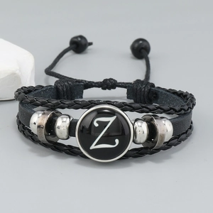 Detail of multi-layer black leather bracelet with letter Z charm and adjustable cord