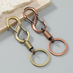 Vintage S-shaped dual metal keychains in bronze and red copper with spring hooks
