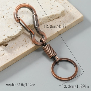 Vintage red copper zinc alloy keychain with lucky Chinese engraving on a stone background