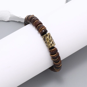 Close-up of retro handmade beaded bracelet featuring coconut shell beads and hammered metal tube