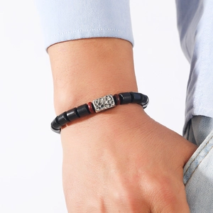 Minimalist handmade beaded bracelet for men featuring black matte beads and silver metal detail
