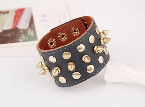 Detail of Punk leather bracelet with gold metal spikes and snap button closure