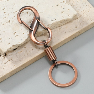Detail of S-shaped antique bronze keychain hook with vintage brushed metal texture