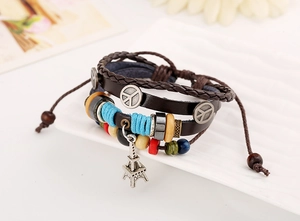 Detail of bohemian layered leather bracelet with colorful beads and Eiffel Tower charm