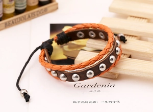 Detail view of woven punk bracelet with silver studs and adjustable cord closure