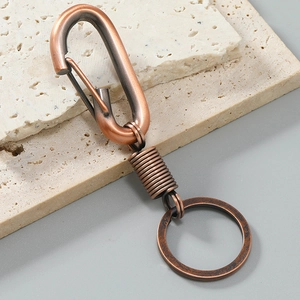 Macro shot of retro bronze alloy keychain with D-ring clasp and industrial spring design