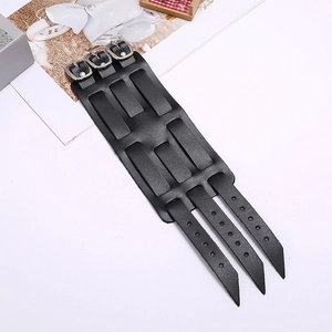 Détail d'un bracelet large en cuir punk noir avec trois boucles en métal argenté