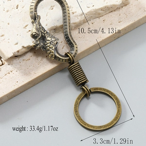 Vintage bronze dragon car keychain made of heavy alloy with dimensions and weight specs