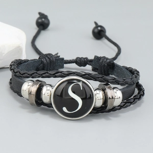 Close-up of multi-layer leather bracelet with letter S charm and silver beads