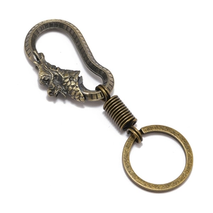 Retro dragon head keychain in bronze alloy with engraved details and spring hook