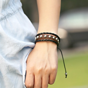Punk brown leather rivet bracelet with black braided cords and adjustable pull string