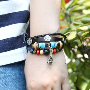 Multilayer leather beaded bracelet featuring Peace sign and Eiffel Tower charms on wrist