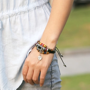 Handmade multilayer beaded leather bracelet with vintage silver charms on a wrist