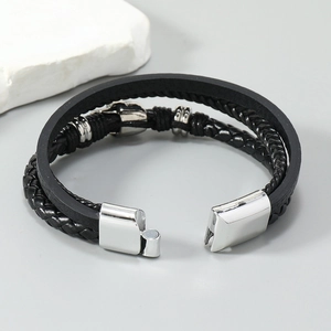 Detail of multi-layer braided leather bracelet with silver beads and magnetic clasp