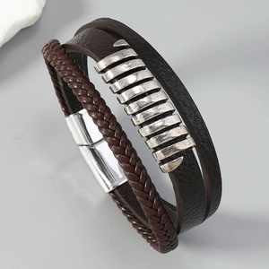 Macro detail of multi-layer woven leather bracelet with vintage silver magnetic clasp