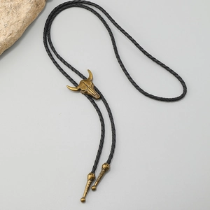Detail of vintage western bolo tie with bronze bull head slider on black leather rope