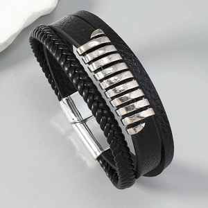 Detail of multi-layer black leather bracelet with silver bars and magnetic clasp