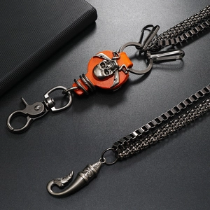 Detail of punk double-layer metal pant chain with skull orange leather ornament