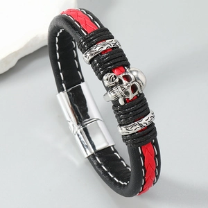 Close-up of punk braided leather bracelet with red cord, silver skull and magnetic clasp