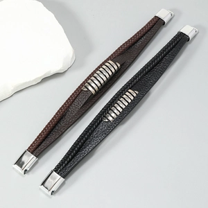 Close-up of black and brown multi-layer braided leather bracelets with magnetic clasps