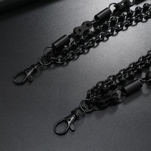 Detail of multi-layered matte black punk metal trousers chain with lobster clasps