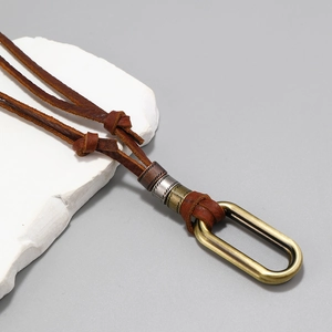 Adjustable long leather sweater necklace with vintage mixed metal rings on white stone