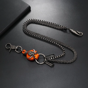 Detail of punk jeans chain with double silver chains and skull leather pendant charm