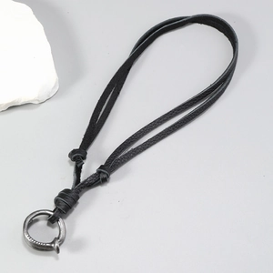 Close-up of adjustable black leather cord with a vintage silver metal ring pendant