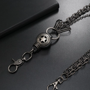 Close-up of triple-layered punk waist chain featuring a vintage star medal and lobster clasps