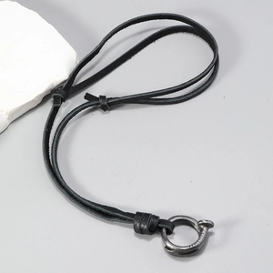 Adjustable black leather cord necklace featuring a vintage silver nail hoop pendant