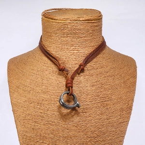 Detail of adjustable leather cord with vintage distressed metal nail pendant on a bust