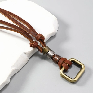Detail of vintage leather cord necklace with multi-colored rustic metallic cylinder beads