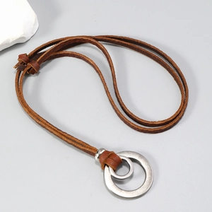 Vintage leather cord necklace with double minimalist interlocked rings on a grey background