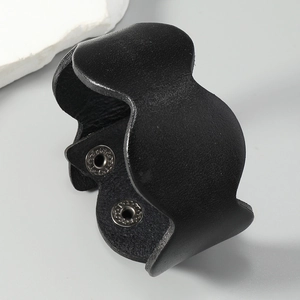 Detail view of black leather wide bracelet featuring adjustable dual metal snap buttons