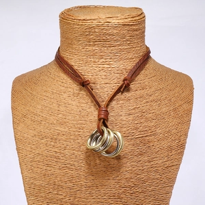 Detail of vintage multi-layered leather cord necklace with nested metallic rings
