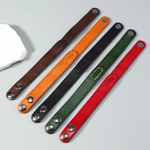 Detail of five-color vintage genuine leather bracelets with durable metal snap buttons