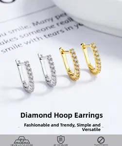 Close-up of gold and silver S925 sterling silver hoop earrings with pavé zircon stones
