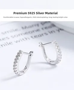 Close-up of 925 sterling silver hoop earrings with shimmering white zircon stones