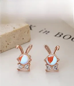 Detail of rose gold rabbit earrings with moonstone body and white rhinestone accents