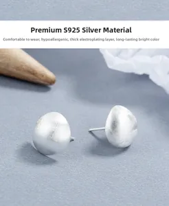 Macro detail of S925 sterling silver stud earring showing frosted matte finish texture