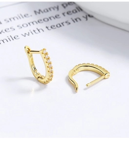 Macro detail of gold plated S925 sterling silver hoop earrings with sparkling zircon stones