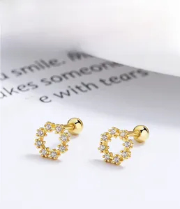 Macro shot of 925 sterling silver gold plated floral zircon earrings with screw back ball