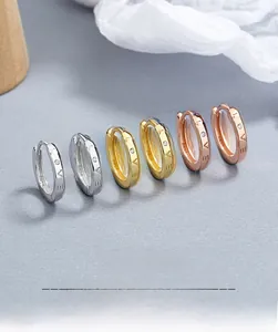 Close-up of S925 sterling silver LOVE earrings with cubic zirconia in three colors