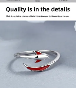 Macro detail of 925 sterling silver koi fish ring with vibrant red enamel accents