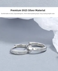 Detail of S925 sterling silver hoop earrings with LOVE engraving and zircon inlay
