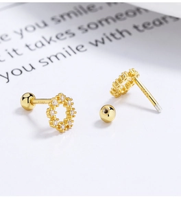 Macro detail of 925 sterling silver gold plated round zircon earrings with screw back ball