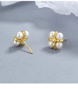 Macro shot of S925 sterling silver stamp on clover-shaped pearl stud earrings