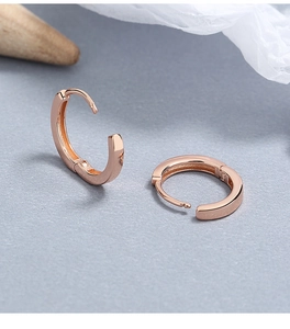 Macro shot of rose gold hoop earrings with polished finish and secure spring clasp closure